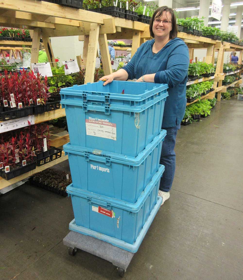 Blue stacking bins on a push cart