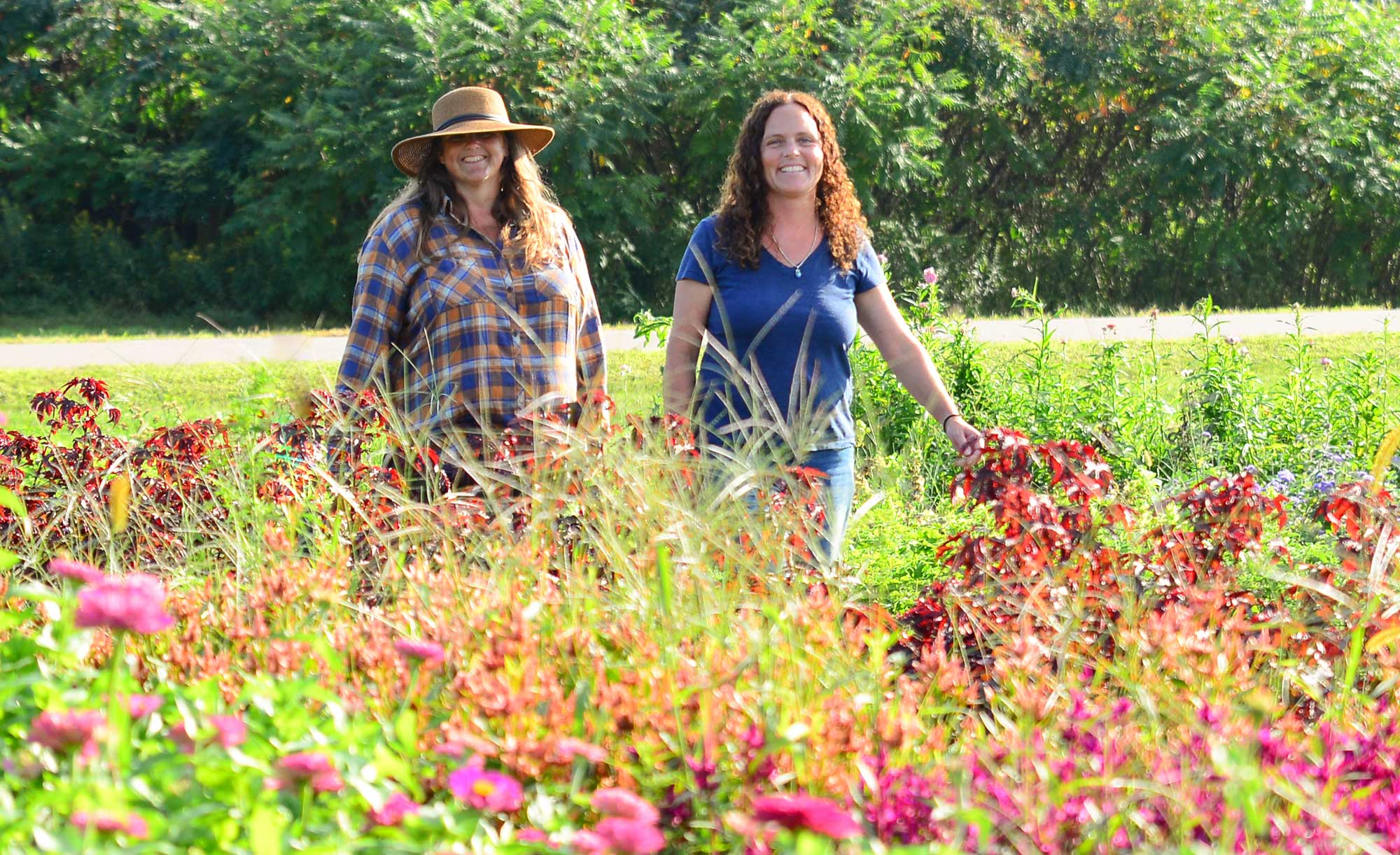 Two women walking in a field of flowers