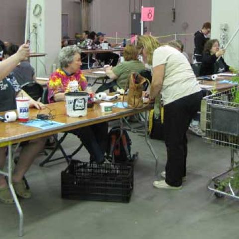 People sitting at a table helping shoppers check out