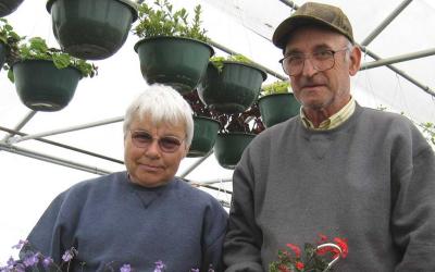 Mertyann and Art Boe in a greenhouse 