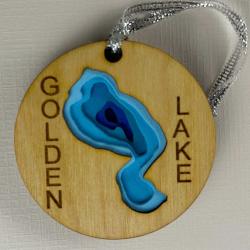 Round wooden ornament with words Golden Lake and center cut 3D in lake shape, painted in blue shades
