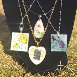 Four necklaces with flowers pressed into various shapes