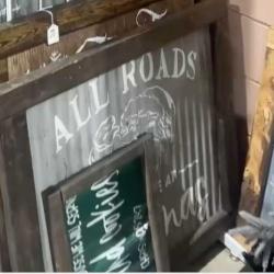 Corrugated metal sign with white lettering